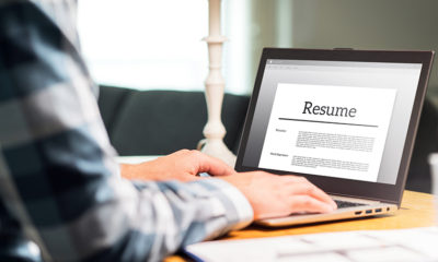 man-creating-resume-on-laptop